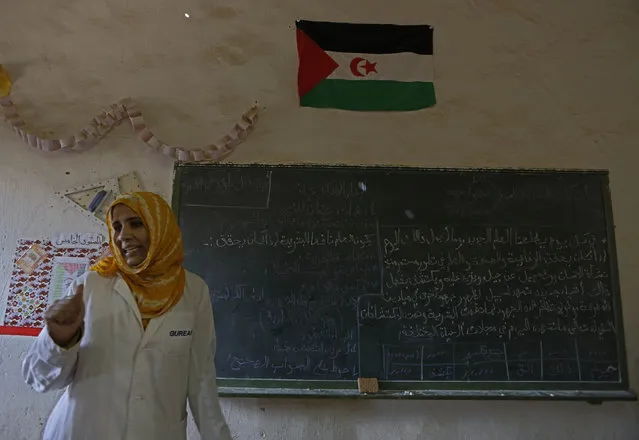 An indigenous Sahrawi teacher attends a class at a school in a refugee camp of Boudjdour in Tindouf, southern Algeria March 3, 2016. (Photo by Zohra Bensemra/Reuters)
