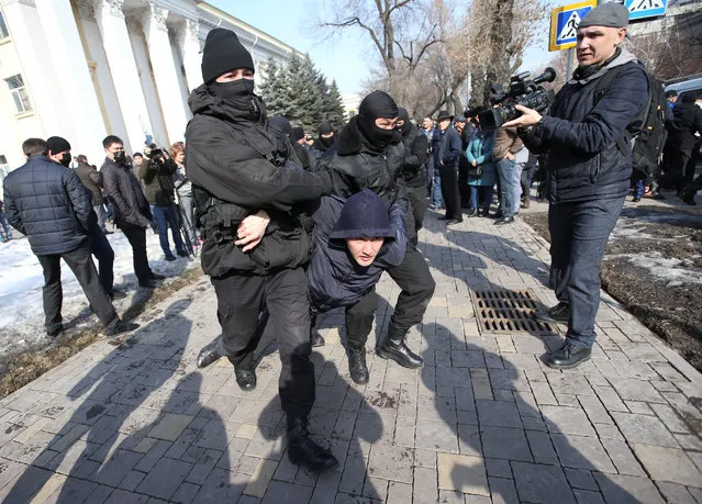 Law enforcement officers detain a man during a rally held by opposition supporters in Almaty, Kazakhstan February 27, 2019. (Photo by Pavel Mikheyev/Reuters)