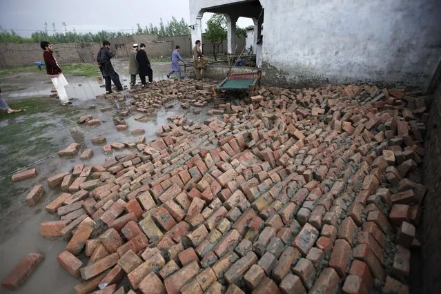 People try to salvage their belongings from their home following torrential rains in Peshawar, Pakistan, 27 April 2015. (Photo by Bilawal Arbab/EPA)