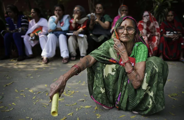 An elderly Indian woman listens to a speaker as she participates in a protest on International Women's Day in New Delhi, India, Tuesday, March 8, 2016. Activists were demanding that the Women's Reservation Bill, which would reserve Indian legislative seats for women, be passed by the Parliament among other demands. (Photo by Altaf Qadri/AP Photo)