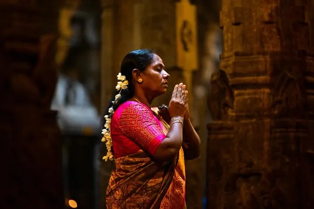 A Hindu devotee offers prayers during the celebrations to mark Diwali, the Hindu festival of lights, at a temple in Colombo on November 12, 2023. (Photo by Ishara S. Kodikara/AFP Photo)