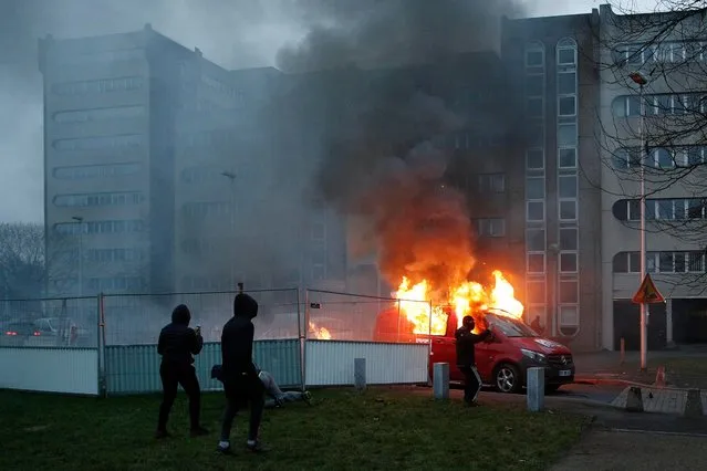 An French radio “RTL” van burns as protesters clash with French riot police in Bobigny, a suburb of Paris, France, 11 February 2017, after attending a demonstration in support of Theo, a young man who was hospitalised for an emergency surgery after he was allegedly sodomized with a truncheon during a police check. (Photo by Yoan Valat/EPA)