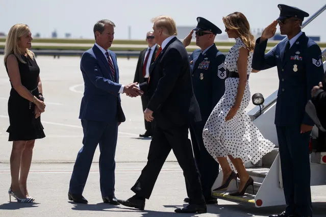 Georgia Gov. Brian Kemp, R-Ga., and his wife Marty Kemp greet President Donald Trump and first lady Melania Trump as they arrive at Hartsfield-Jackson International Airport to attend the "Rx Drug Abuse and Heroin Summit," Wednesday, April 24, 2019, in Atlanta. (Photo by Evan Vucci/AP Photo)