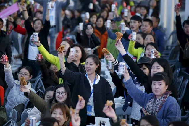 Chinese tourists make a toast with canned drinks and fried chicken pieces during an event organized by a Chinese company at a park in Incheon, South Korea, March 28, 2016. (Photo by Kim Hong-Ji/Reuters)