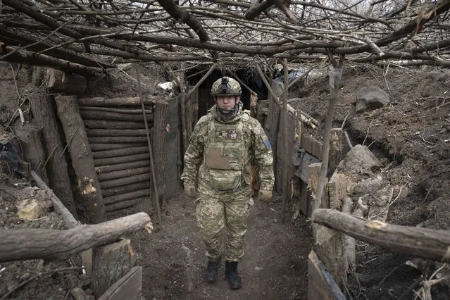 A Ukrainian serviceman of the 28th Separate Mechanised Brigade stands in a trench at the front line, near Bakhmut, Donetsk region, Ukraine, Sunday, March 3, 2024. (Photo by Efrem Lukatsky/AP Photo)