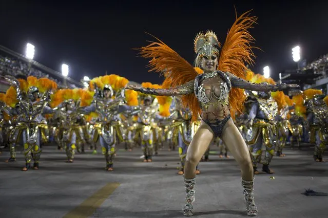 Performers from the Unidos da Tijuca samba school parade during carnival celebrations at the Sambadrome in Rio de Janeiro, Brazil, Tuesday, March 4, 2014. Brazil's Carnival is maintaining its frenetic pace, with hundreds of roving parties taking over Rio de Janeiro's streets and famed samba school parades heading into their final night. (Photo by Felipe Dana/AP Photo)