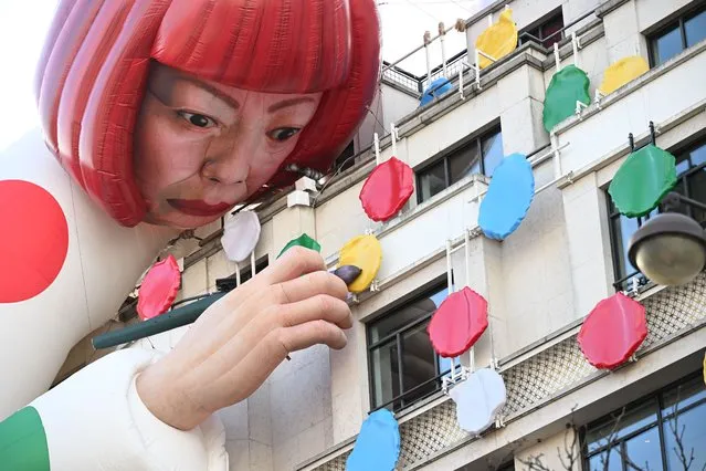 This photo taken on January 13, 2023, shows a large inflatable mannequin depicting Japanese contemporary artists Yayoi Kusama decorating the French luxury brand Louis Vuitton flagship store on the Champs-Elysees avenue in Paris. (Photo by Emmanuel Dunand/AFP Photo)