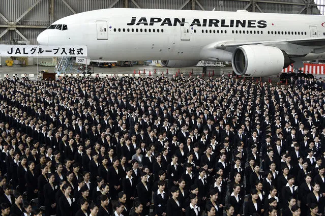 New employees of Japan Airlines (JAL) attend a company entrance ceremony at a maintenance hangar in Haneda airport in Tokyo, Japan, 01 April 2016. More than 1,450 new recruits of the JAL group attended the event on the first day of the fiscal year in Japan. (Photo by Franck Robichon/EPA)