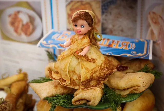 A doll decorated with pancakes is seen at a fair for celebration of Maslenitsa, or Pancake Week, in Almaty, Kazakhstan, February 25, 2017. (Photo by Shamil Zhumatov/Reuters)