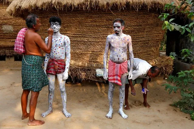Devotees get their bodies painted before taking part in a ritual as part of the annual Shiva Gajan religious festival at Sona Palasi village, in West Bengal, India, April 11, 2016. (Photo by Rupak De Chowdhuri/Reuters)