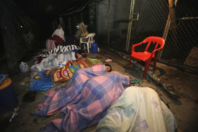 Residents sleep in the street in the Pacific coastal town of Pedernales, Ecuador, Sunday, April 17, 2016. The strongest earthquake to hit Ecuador in decades flattened buildings and buckled highways along its Pacific coast, sending the Andean nation into a state of emergency. As rescue workers rushed in, officials said Sunday at least 77 people were killed, over 570 injured and the damage stretched for hundreds of miles to the capital and other major cities. (Photo by Dolores Ochoa/AP Photo)