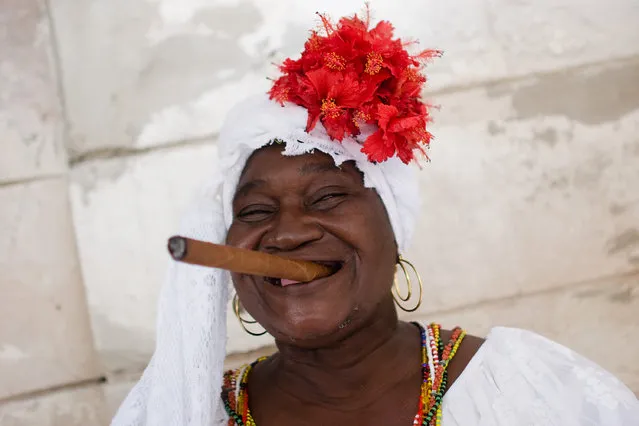 An old woman smokes a cigar at Old Havana's Plaza de la Catedral on February 07, 2006 in Havana, Cuba. (Photo by Marco Prosch/Getty Images)