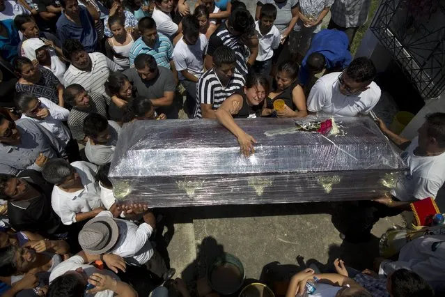 Relatives cry over the coffin of Kexly Valentino who died with her mother Gabriela and her brother Alex in the earthquake, in Montecristi, Ecuador, Tuesday, April 19, 2016. The strongest earthquake to hit Ecuador in decades flattened buildings and buckled highways along its Pacific coast, sending the Andean nation into a state of emergency. (Photo by Rodrigo Abd/AP Photo)