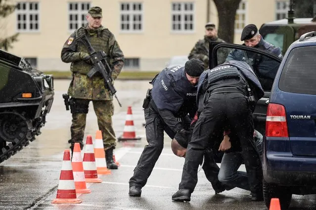 Members of the Bavarian police and the Bundeswehr, the German armed forces, intercept a vehicle at a checkpoint during a demonstration as part of the GETEX anti-terror exercises during a media event on March 9, 2017 in Murnau, Germany. (Photo by Philipp Guelland/Getty Images)