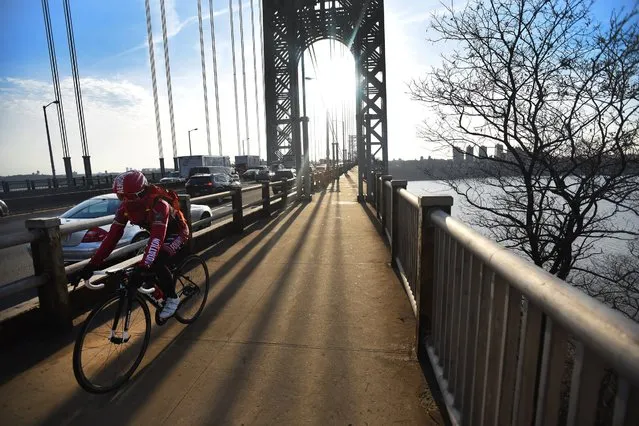 A cyclist rides on the George Washington Bridge from New York, Thursday, March 24, 2016. (Photo by Mitsu Yasukawa/The Record of Bergen County via AP Photo)