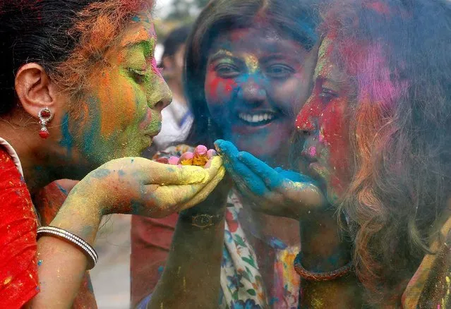 Students of Rabindra Bharati University blow colour powder during Holi, the Festival of Colours, celebrations inside the university campus in Kolkata, India, March 9, 2017. (Photo by Rupak De Chowdhuri/Reuters)