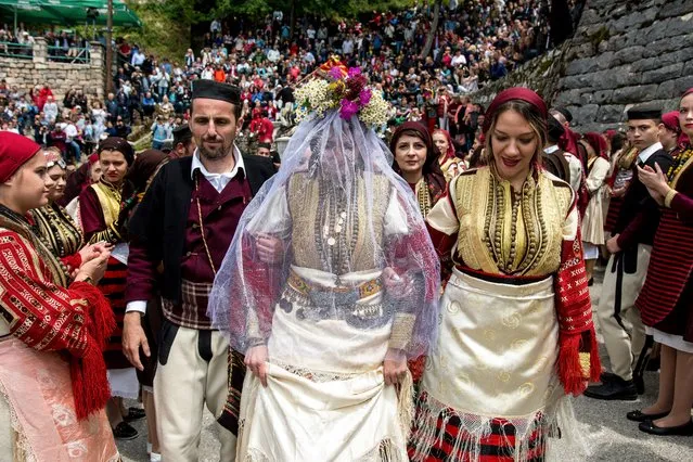 A bride walks during a traditional wedding ceremony in the western Macedonian village of Galicnik, 150km southwest of Skopje, during the Galicnik Wedding Festival on July 13, 2019. Every year, during the Christian Orthodox holiday Petrovden (St Peters Day), Macedonians originating from Galicnik gather in this deserted mountainous village and a selected couple gets married in the traditional “Galichka” style wedding. (Photo by Robert Atanasovski/AFP Photo)