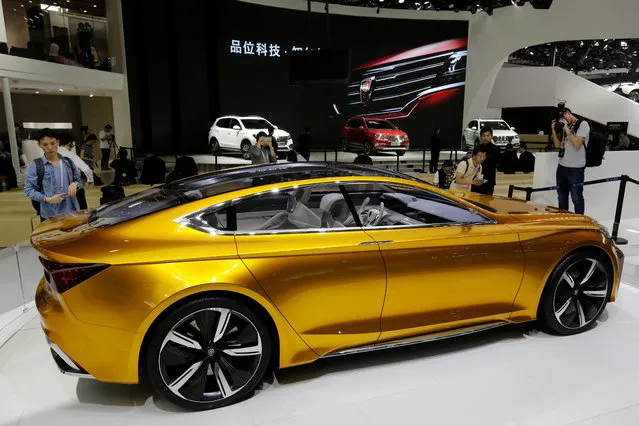 Journalists take pictures of the Roewe Vision R Concept on display at the Beijing International Automotive Exhibition in Beijing, Monday, April 25, 2016. (Photo by Andy Wong/AP Photo)