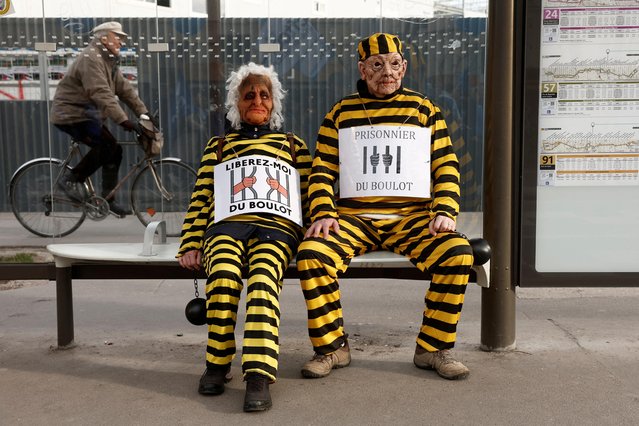 Protesters dressed in mock prison outfits attend a demonstration against French government's pension reform plan in Paris as part of the fifth day of national strike and protests in France on February 16, 2023. The slogans read "Free me from work" and “prisoner of work”. (Photo by Benoit Tessier/Reuters)