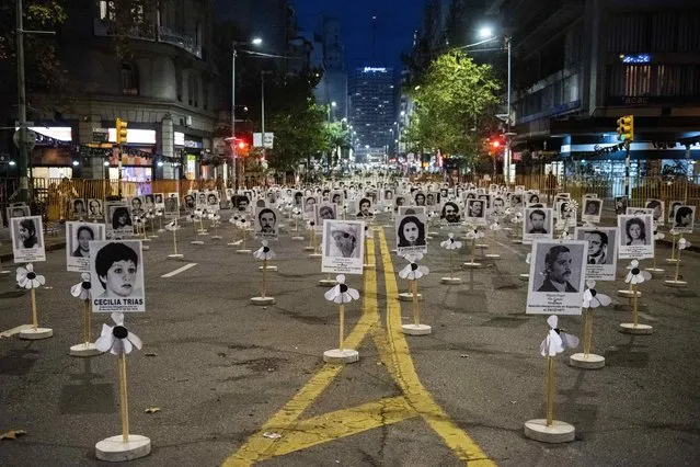 The images of those who disappeared during the military dictatorship are displayed in downtown Montevideo, Uruguay, Thursday, May 20, 2021. The annual March of Silence, which honors the disappeared, was suspended for a second year in a row due to the COVID-19 pandemic. (Photo by Matilde Campodonico/AP Photo)