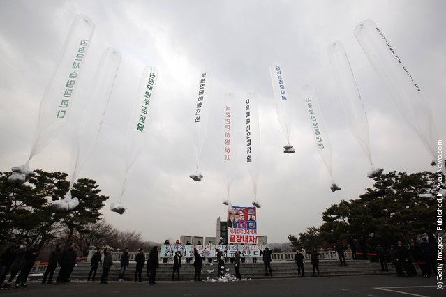 North Korean defectors, now living in South Korea, prepare to release balloons carrying propaganda leaflets denouncing North Korea's late leader Kim Jong-Il at Imjingak, near the Demilitarized zone