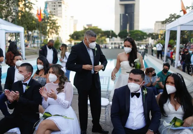 Newlywed couples attend a community wedding ceremony in Plaza Altamira during Valentine's Day in Caracas, Venezuela on February 14, 2022. (Photo by Leonardo Fernandez Viloria/Reuters)