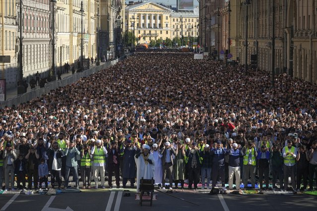 Muslims offer Eid al-Adha prayers at the Moskovsky central avenue during celebrations in St. Petersburg, Russia, Sunday, June 16, 2024. Muslims around the world celebrate Eid al-Adha, or the Feast of the Sacrifice, slaughtering sheep, goats, cows and camels to commemorate Prophet Abraham's readiness to sacrifice his son Ismail on God's command. (Photo by Dmitri Lovetsky/AP Photo)