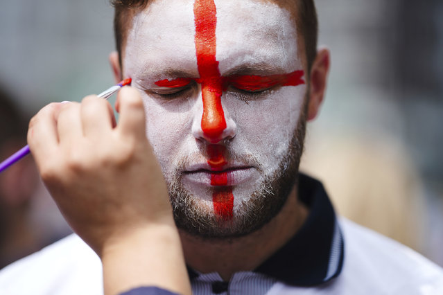 An England fan gets his face painted ahead for the round of sixteen match between England and Slovakia at the Euro 2024 soccer tournament in Gelsenkirchen, Germany, Sunday, June 30, 2024. (Photo by Markus Schreiber/AP Photo)