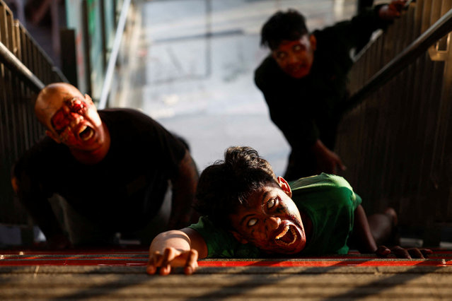 People perform as zombies during the “Train to Apocalypse: No Way Out” event, held to entertain commuters and attract people to use Light Rail Transit (LRT) train, in Jakarta, Indonesia, on July 16, 2024. (Photo by Willy Kurniawan/Reuters)