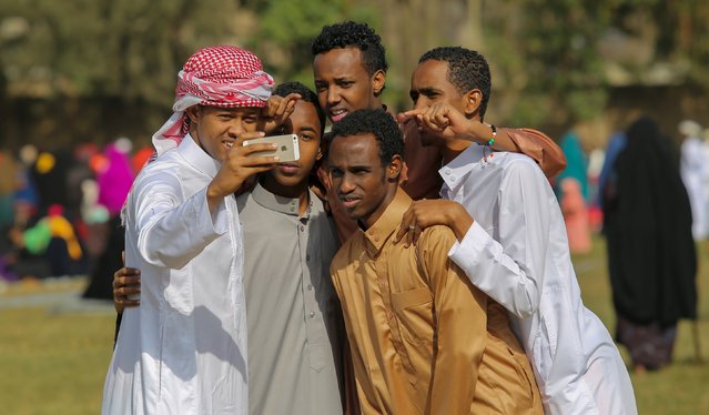 Muslim faithfuls take a selfie photograph after attending in morning prayers to celebrate the first day of the Muslim holiday of Eid-al-Fitr, marking the end of the holy month of Ramadan, at the Eastleigh High School in Eastleigh, a suburb in Nairobi predominantly inhabited by Somali immigrants within Kenya's capital Nairobi, July 17, 2015. (Photo by Boniface Mwangi/Reuters)