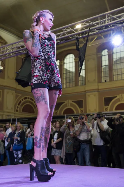 A model poses on the mainstage during the Vintage Alternative Fashion Show at The Great British Tattoo Show at Alexandra Palace on May 24, 2014 in London, England. (Photo by Tristan Fewings/Getty Images for Alexandra Palace)