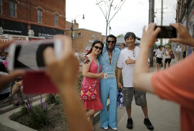 Elvis Presley tribute artist Lorenz Francke of Scarborough, Ontario poses with fans during the four-day Collingwood Elvis Festival in Collingwood, Ontario July 25, 2015. (Photo by Chris Helgren/Reuters)