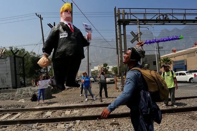 A Central American migrant hits a pinata representing U.S. President Donald Trump during a protest to raise awareness of the migrant crossing between Mexico and the U.S., on the outskirts of Monterrey, Mexico May 27, 2017. (Photo by Daniel Becerril/Reuters)