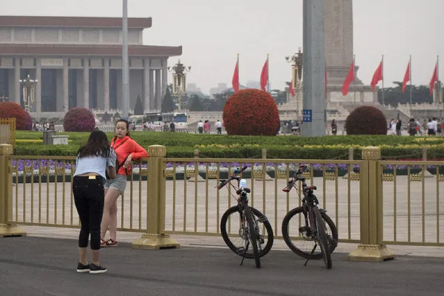 A girl poses for a photo along the barriers surrounding Tiananmen Square in Beijing, Saturday, June 4, 2016. (Photo by Mark Schiefelbein/AP Photo)