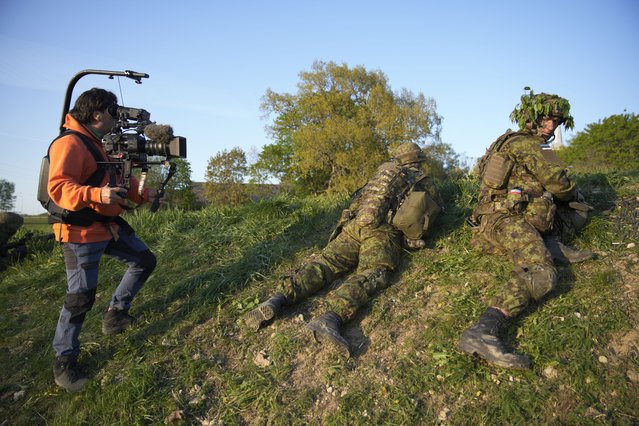 A camera operator films members of the Estonian Defence Forces during the Spring Storm exercises of the NATO Enhanced Forward Presence (eFP) force in Kadrina, Estonia on May 19, 2023. The Spring Storm exercise that kicked off this week is the largest military exercise of the Estonian Defence Forces (EDF) involving allied NATO forces. The Northern and Central Europe NATO forces are organized under the Enhanced Forward Presence (eFP) force currently under leadership of the UK. (Photo by Jaap Arriens/AFP Photo)