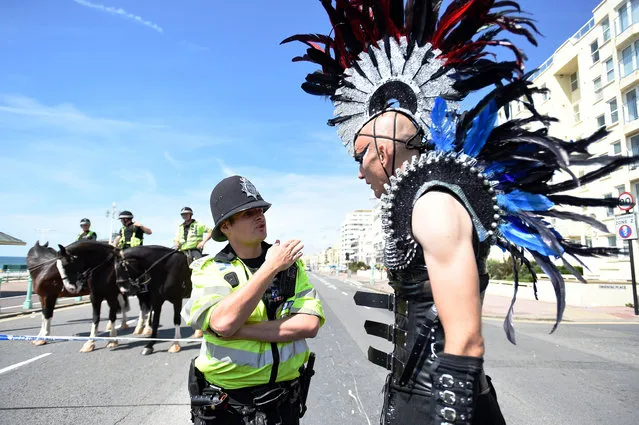 A police officer advises festival goer of the new route that has been set for the parade following a bomb scare during Brighton Pride 2015 on August 1, 2015 in Brighton, England. (Photo by Tabatha Fireman/Getty Images)