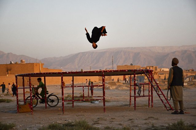 A boy plays on a trampoline on the outskirts of Mazar-i-Sharif on September 11, 2024. (Photo by Atif Aryan/AFP Photo)