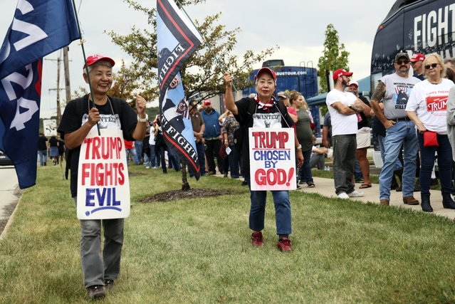 Katie Mimura, left, and Hisako Kaneko, center, who traveled from Japan to show support for Republican presidential nominee former President Donald Trump walk outside before a rally at Ed Fry Arena in Indiana, Pa., Monday, September 23, 2024. (Photo by Rebecca Droke/AP Photo)