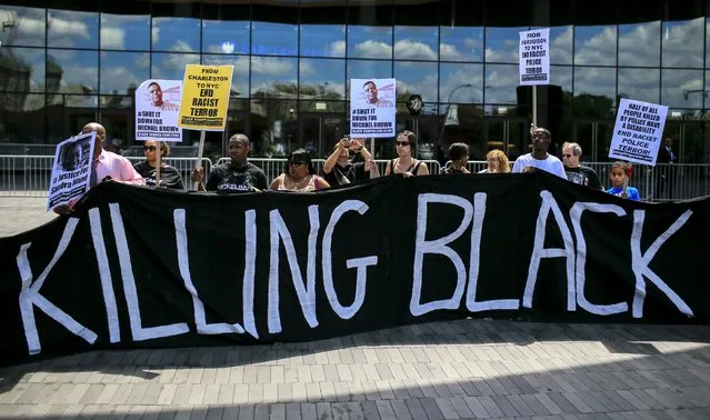 Protesters take part in a rally at Barclays Center marking the first anniversary of the death of Michael Brown, in Brooklyn, New York August 9, 2015. (Photo by Eduardo Munoz/Reuters)