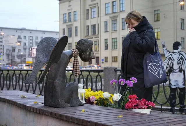 Galina Artyomenko, a local journalist and influential behind the monument, looks at “Sad Angel”, a memorial for St. Petersburg's medical workers who died of coronavirus in St. Petersburg, Russia, Tuesday, October 26, 2021. (Photo by Dmitri Lovetsky/AP Photo)