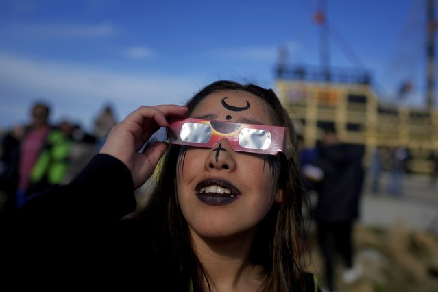 People watch an annular solar eclipse in Puerto San Julian, Argentina, Wednesday, October 2, 2024. (Photo by Natacha Pisarenko/AP Photo)