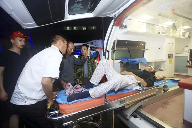 An injured man is taken care of at a hospital in Yancheng city in eastern China's Jiangsu Province on Thursday, June 23, 2016. (Photo by Chinatopix via AP Photo)