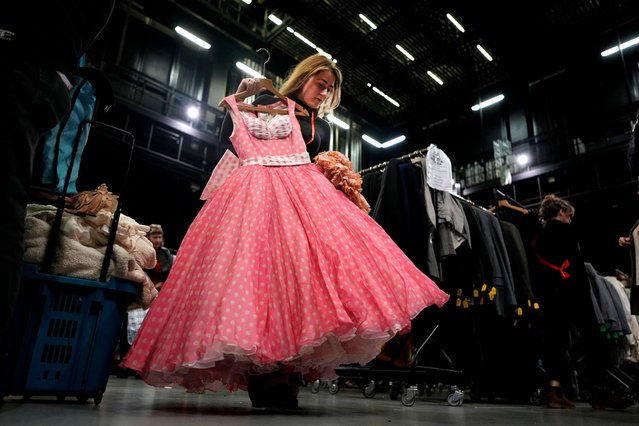 Harriet Jennings looks at a dress during the Royal Ballet and Opera, Costume and Armoury Sale 24, Purfleet in London, Saturday, October 12, 2024. (Photo by Alastair Grant/AP Photo)