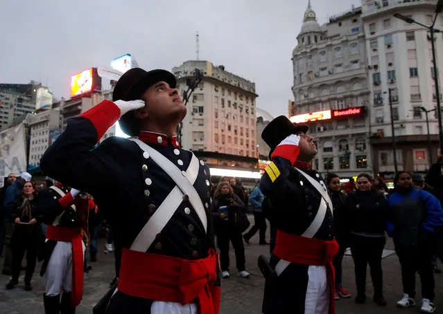 Honour guards from the Patricios regiment salute the national flag as people watch in downtown Buenos Aires, Argentina, July, 14, 2016. (Photo by Marcos Brindicci/Reuters)