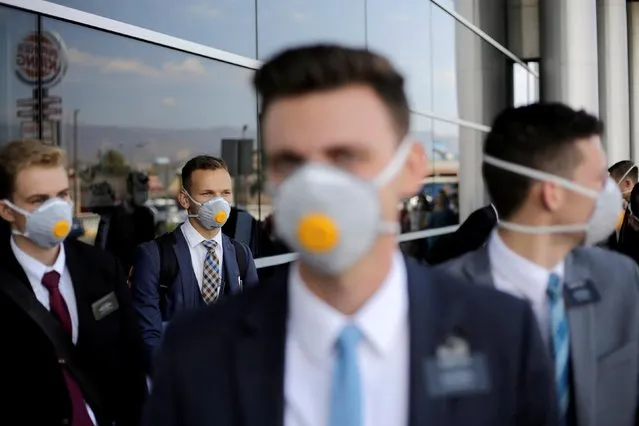 U.S. members of The Church of Jesus Christ of Latter-day Saints, wearing protective masks, gather at Toncontin International airport before heading home, as the coronavirus disease (COVID-19) outbreak continues, in Tegucigalpa, Honduras on March 29, 2020. (Photo by Jorge Cabrera/Reuters)