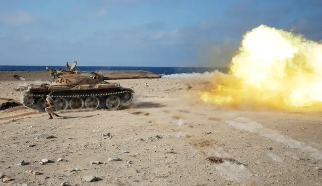 A fighter of Libyan forces allied with the U.N.-backed government fires a shell with Soviet made T-55 tank at Islamic State fighters in Sirte, Libya, August 2, 2016. (Photo by Goran Tomasevic/Reuters)