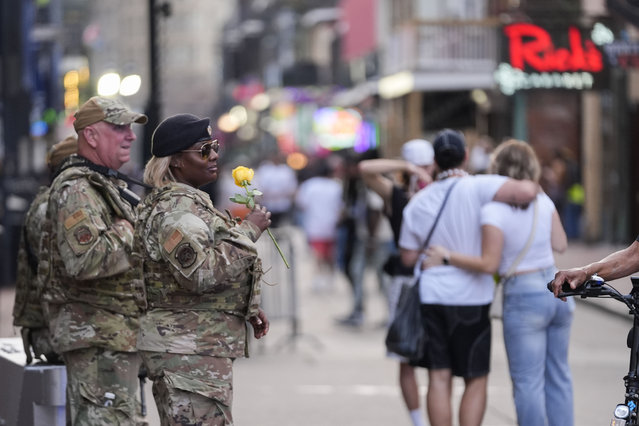 Louisiana National Guard First Sgt. Nicole Williams holds a rose that was given to her by a passer-by, as she mans a security checkpoint on Bourbon Street Wednesday, February 5, 2025, ahead of Super Bowl 59 between the Philadelphia Eagles and the Kansas City Chiefs in New Orleans. (Photo by Gerald Herbert/AP Photo)