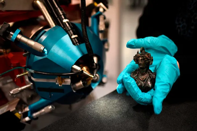 An antique bronze sculpture is analyzed using the latest version of the AGLAE (Louvre accelerator of elemental analysis), an apparatus for the chemical analysis of art and archaeological pieces, at the Louvre museum on November 21, 2017 in Paris. The new AGLAE was carried out in collaboration between the CNRS, C2 RMF and ChimieParistech and co- financed by the programm “Investissement d' avenir”, the city of Paris and the French culture ministry. .The (AGLAE) is a particle accelerator housed by the Center for Research and Restoration of Museums of France in the Louvre museum and used to determine the atomic constituents of cultural items. (Photo by Stephane de Sakutin/AFP Photo)