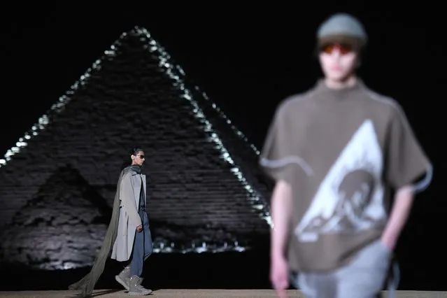 Models present a creation at the Christian Dior fashion show at the Giza Pyramids Necropolis on the outskirts of the twin city of Egypt's capital on December 3, 2022. French fashion house Dior today held its first show at Egypt's ancient Giza pyramids, presenting its 2023 fall men's collection in the shadow of the of the millennia-old tombs. (Photo by Ahmed Hasan/AFP Photo)