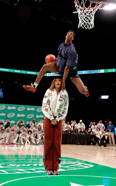 AJ Dybantsa, one of the top-ranked high school basketball players in the United States, leaps over WNBA star Angel Reese during a dunk contest in New York on Monday, March 31, 2025. (Photo by Brian Spurlock/Icon Sportswire/Getty Images)